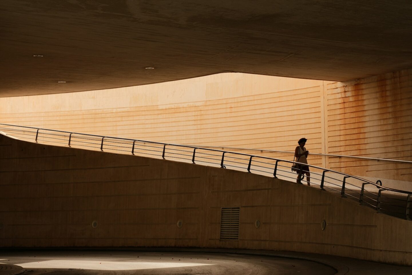 A person walking up a ramp in a building
